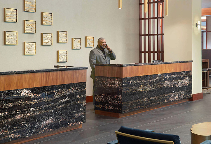 a man standing at a reception desk