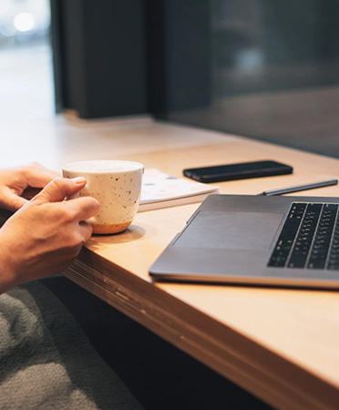 a person holding a cup of coffee
