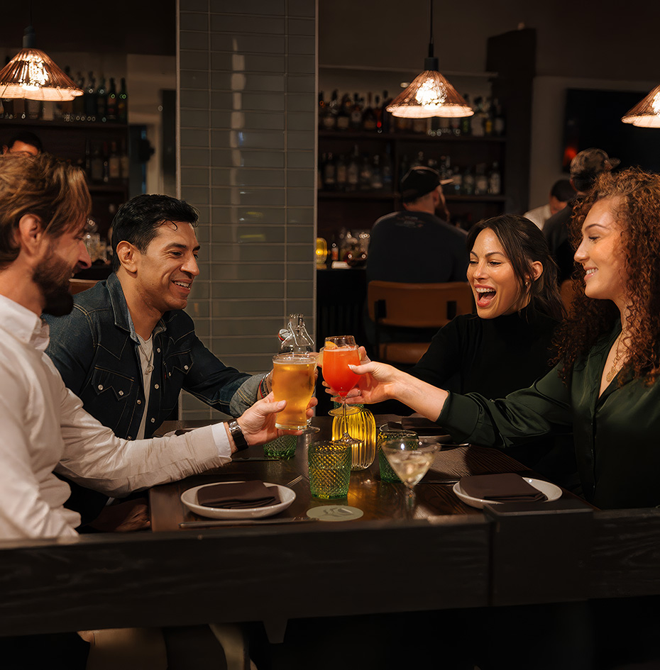 a group of people sitting at a table with drinks