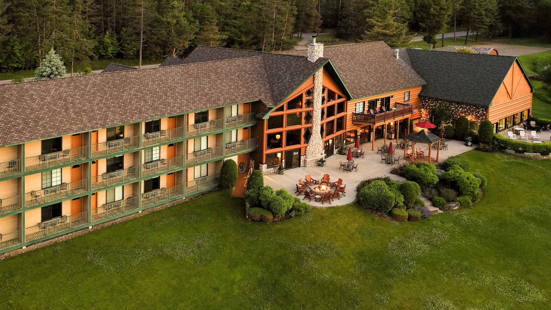 a large building with a lawn and patio