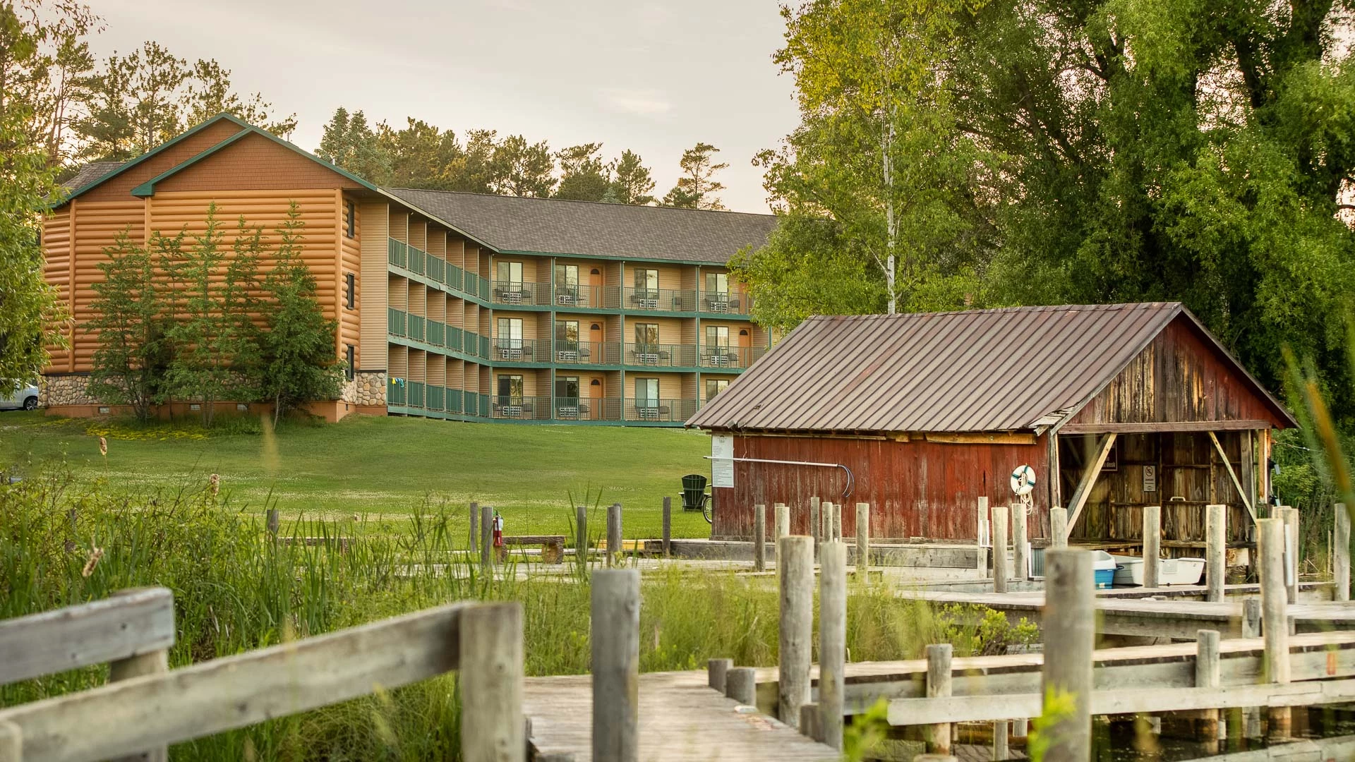 a building with a wooden fence and a wooden bridge