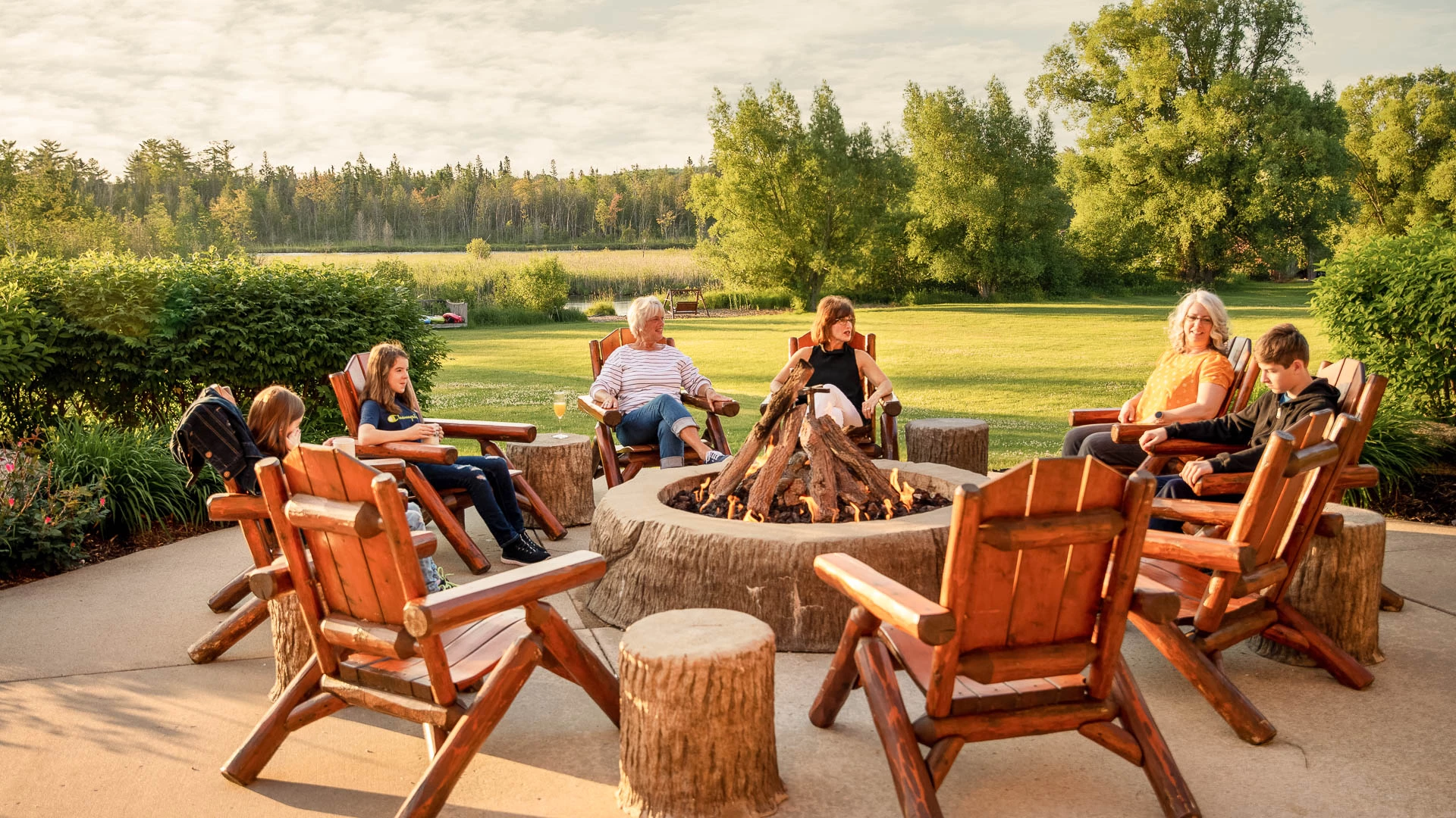 a group of people sitting around a fire pit