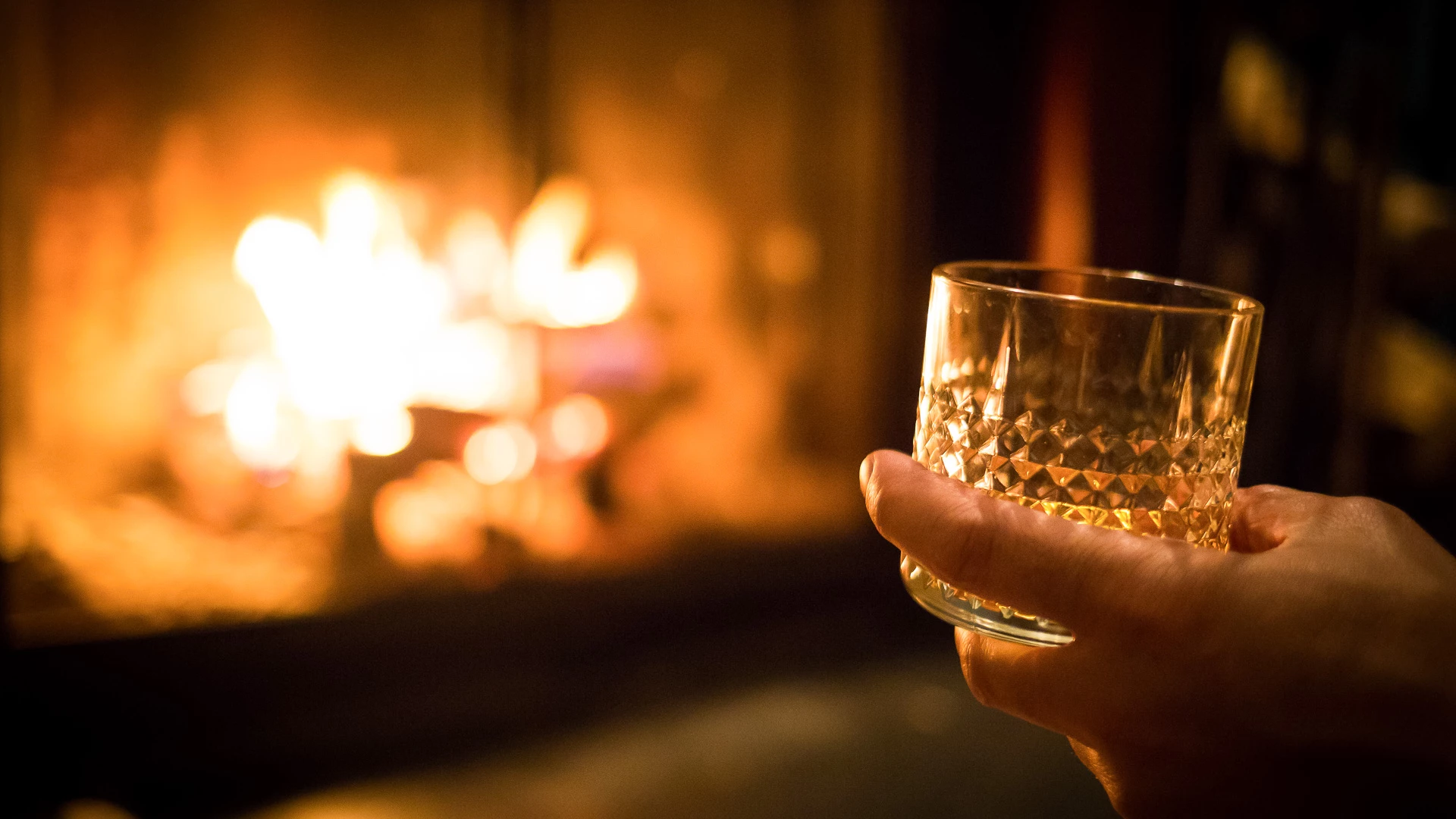 a hand holding a glass of wine