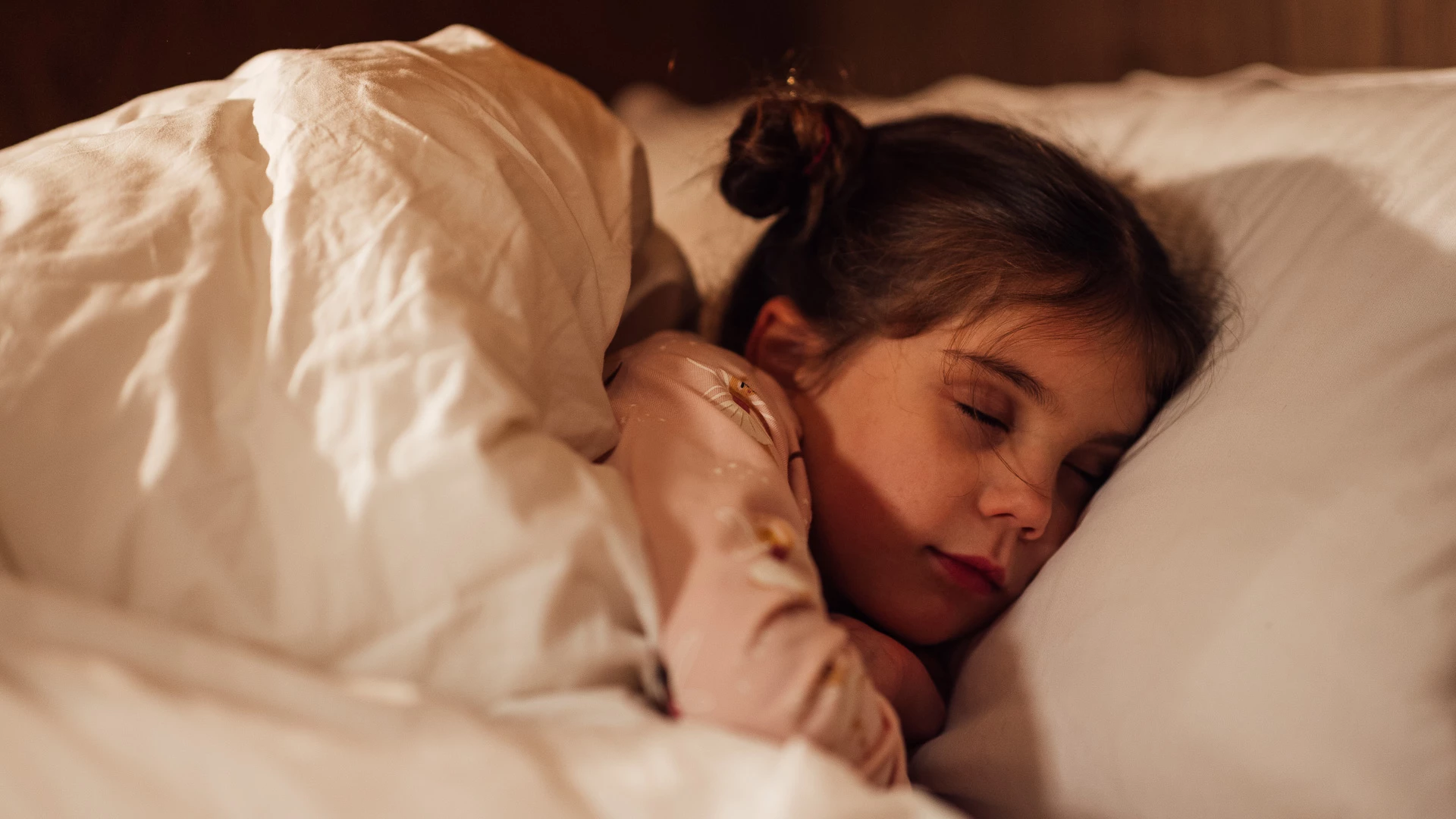 a girl sleeping in a bed