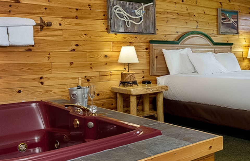 a room with a hot tub and a bed