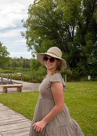 a woman wearing a hat and sunglasses