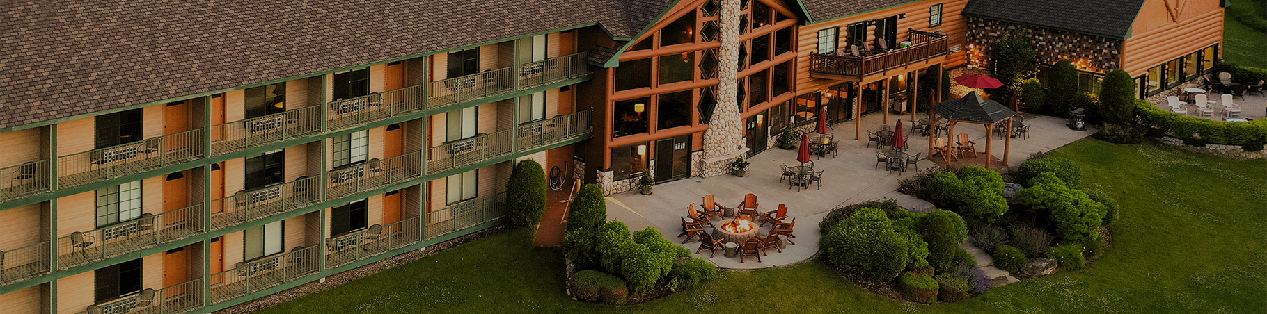 a building with a fire pit and lawn