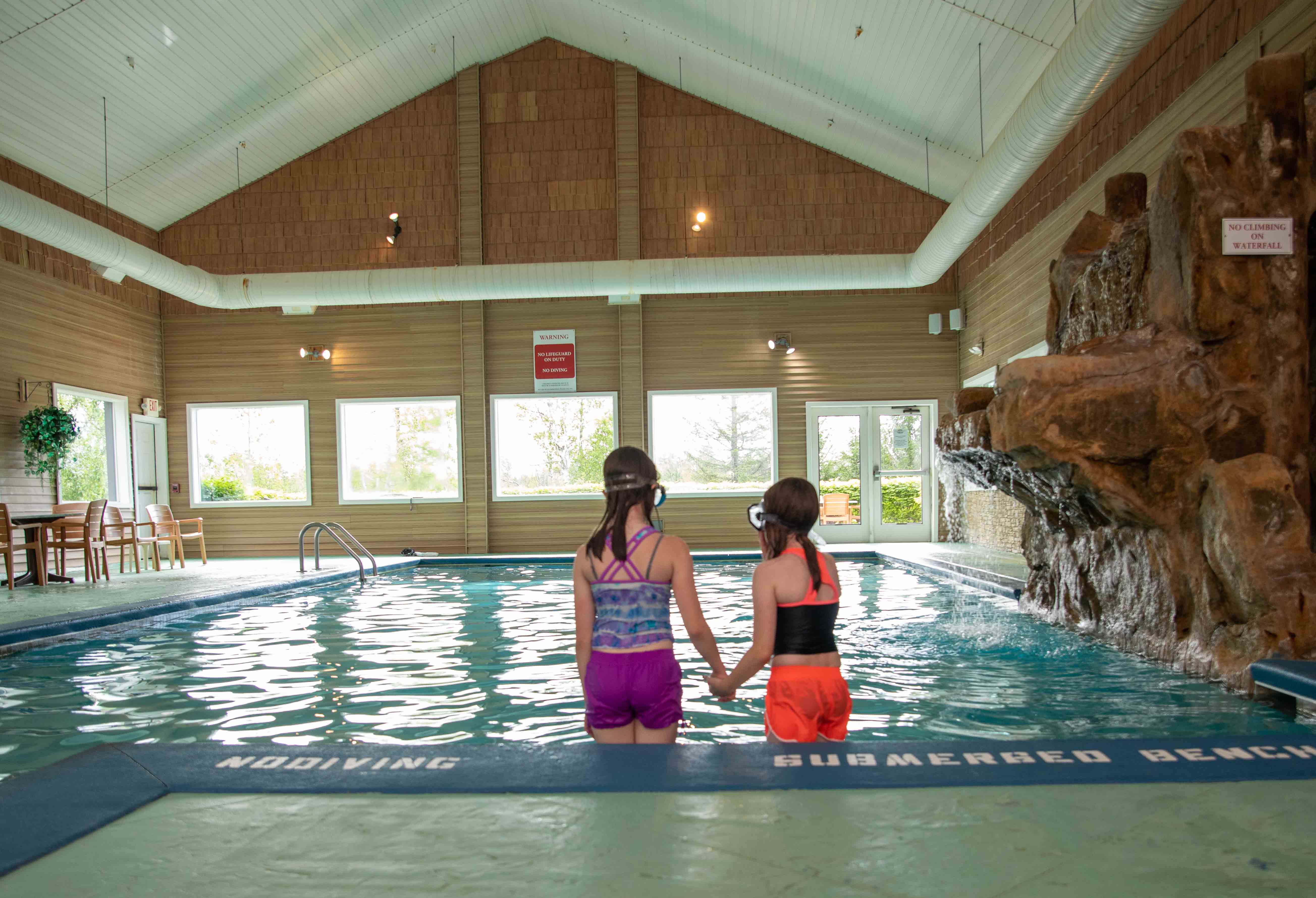 two girls standing in a pool