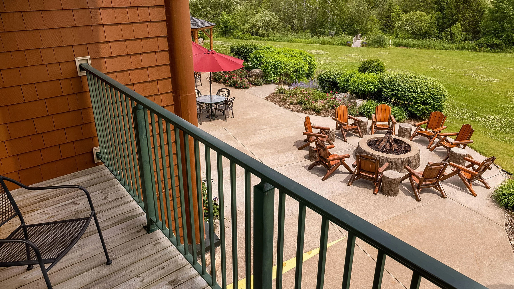 a patio with chairs and a fire pit