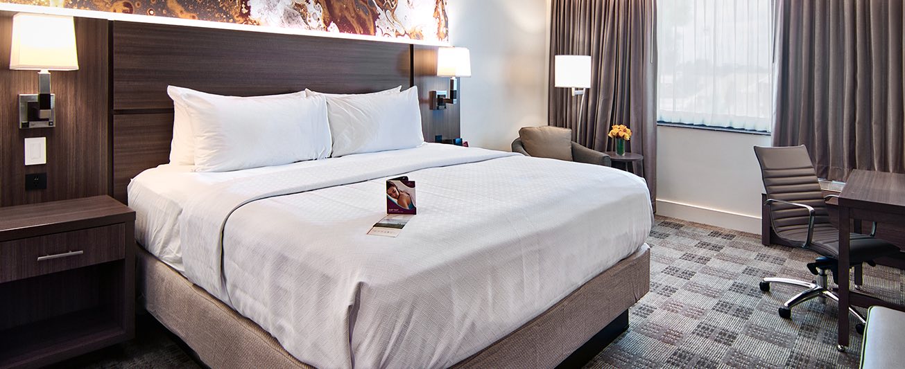 white bed linens in a renovated guest room