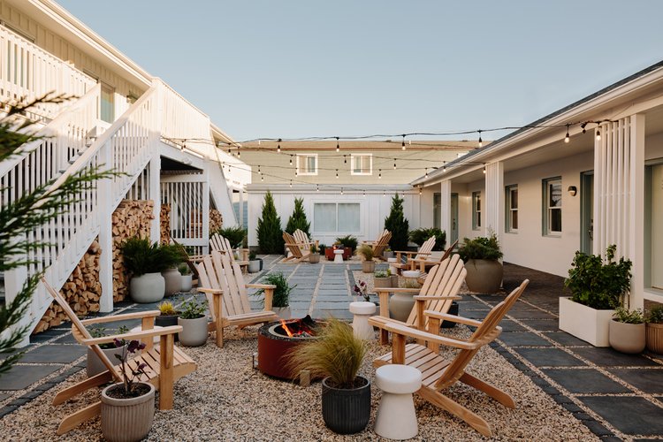 a backyard with a patio and chairs