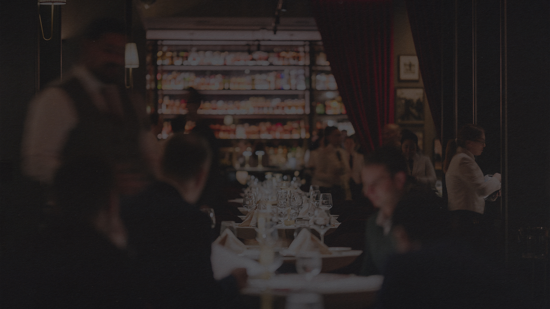 a group of people sitting at tables in a restaurant