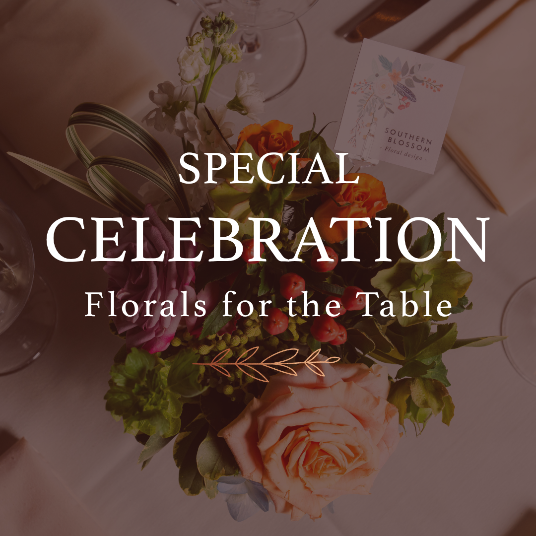 a table with flowers and glasses