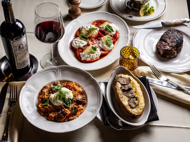 a table with plates of food and wine