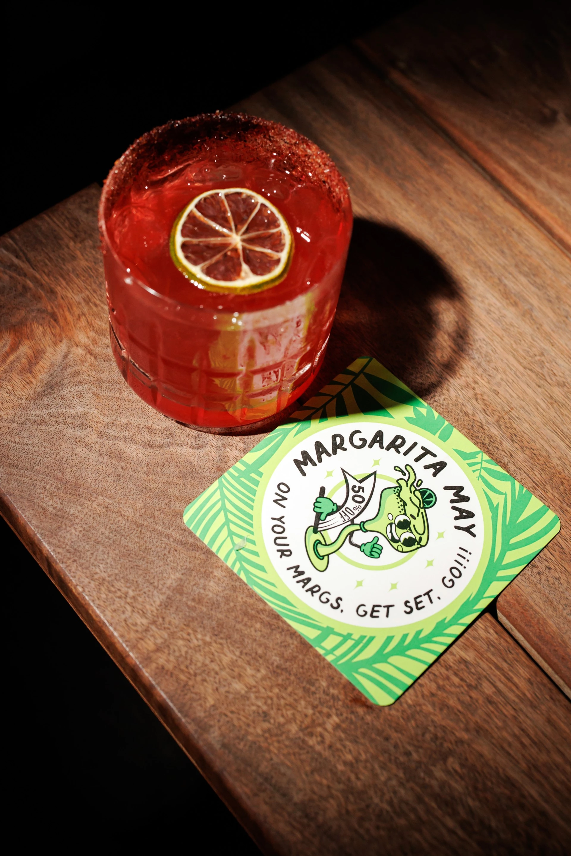 a drink and a sign on a table
