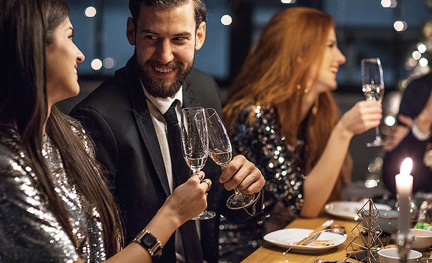 Couple toasting with champagne at table