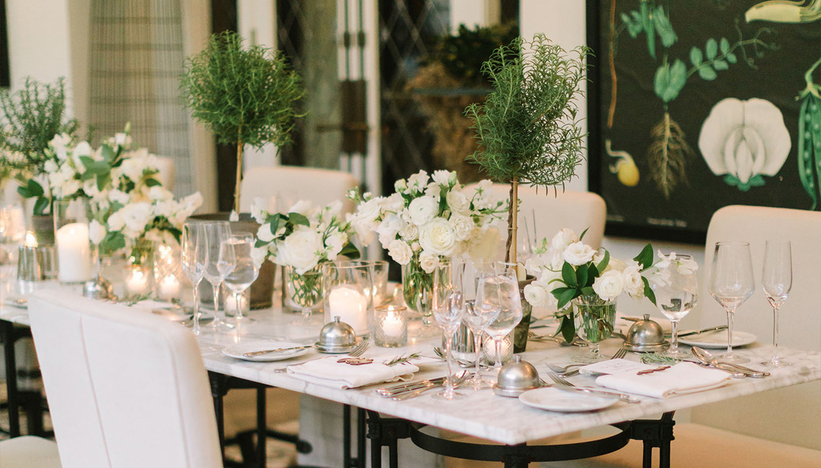 a table with white flowers and candles