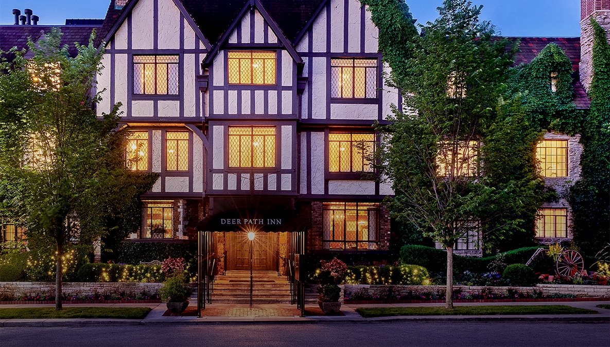 a building with trees and bushes in front of it