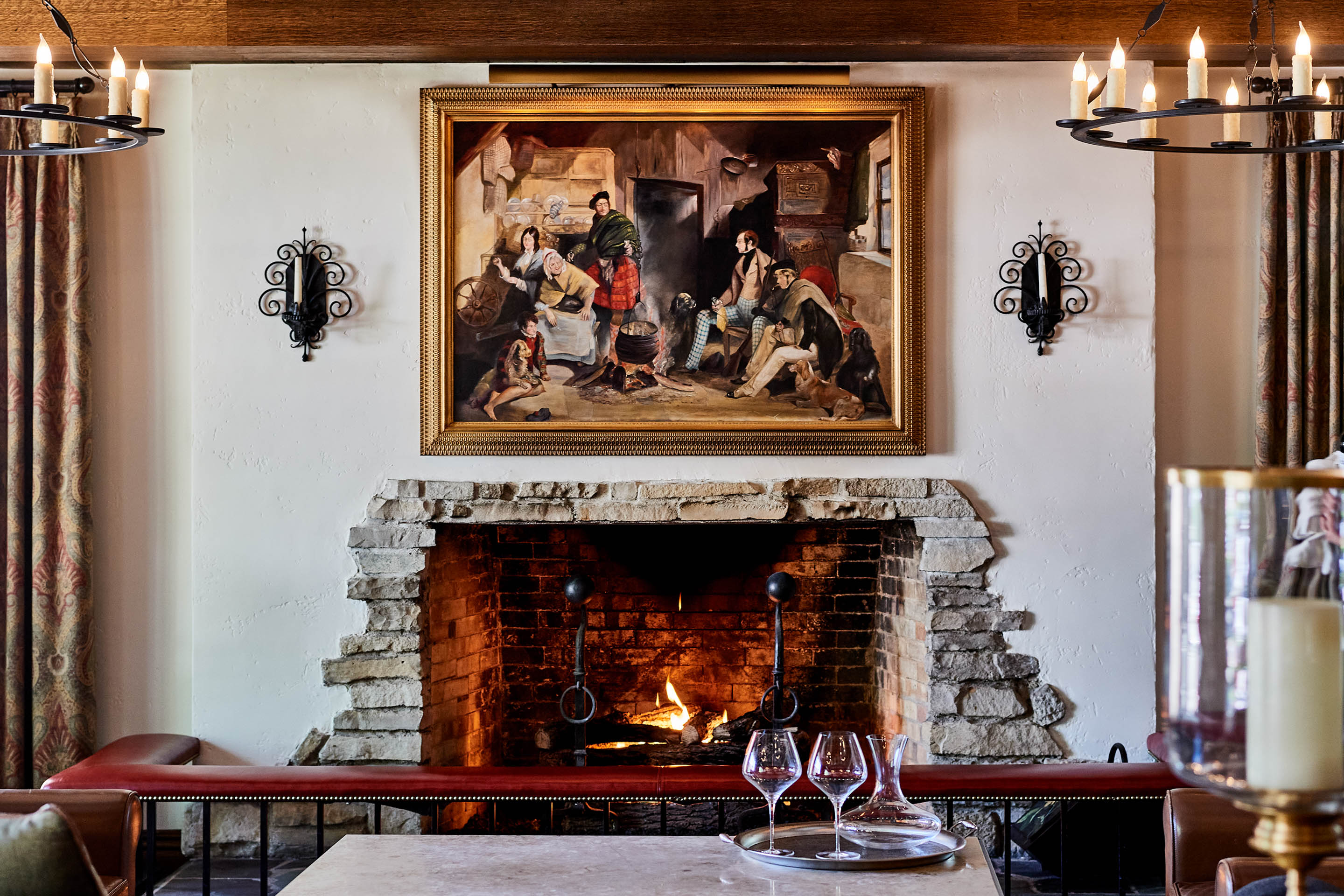 a fireplace with a painting on the wall