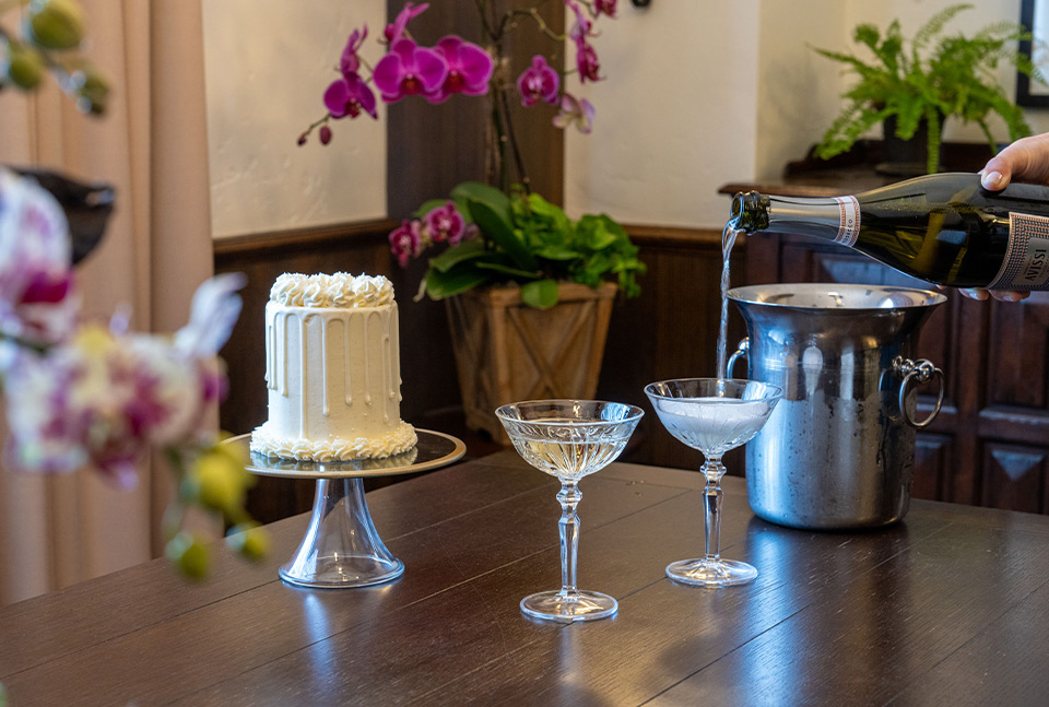 a table with a cake and glasses