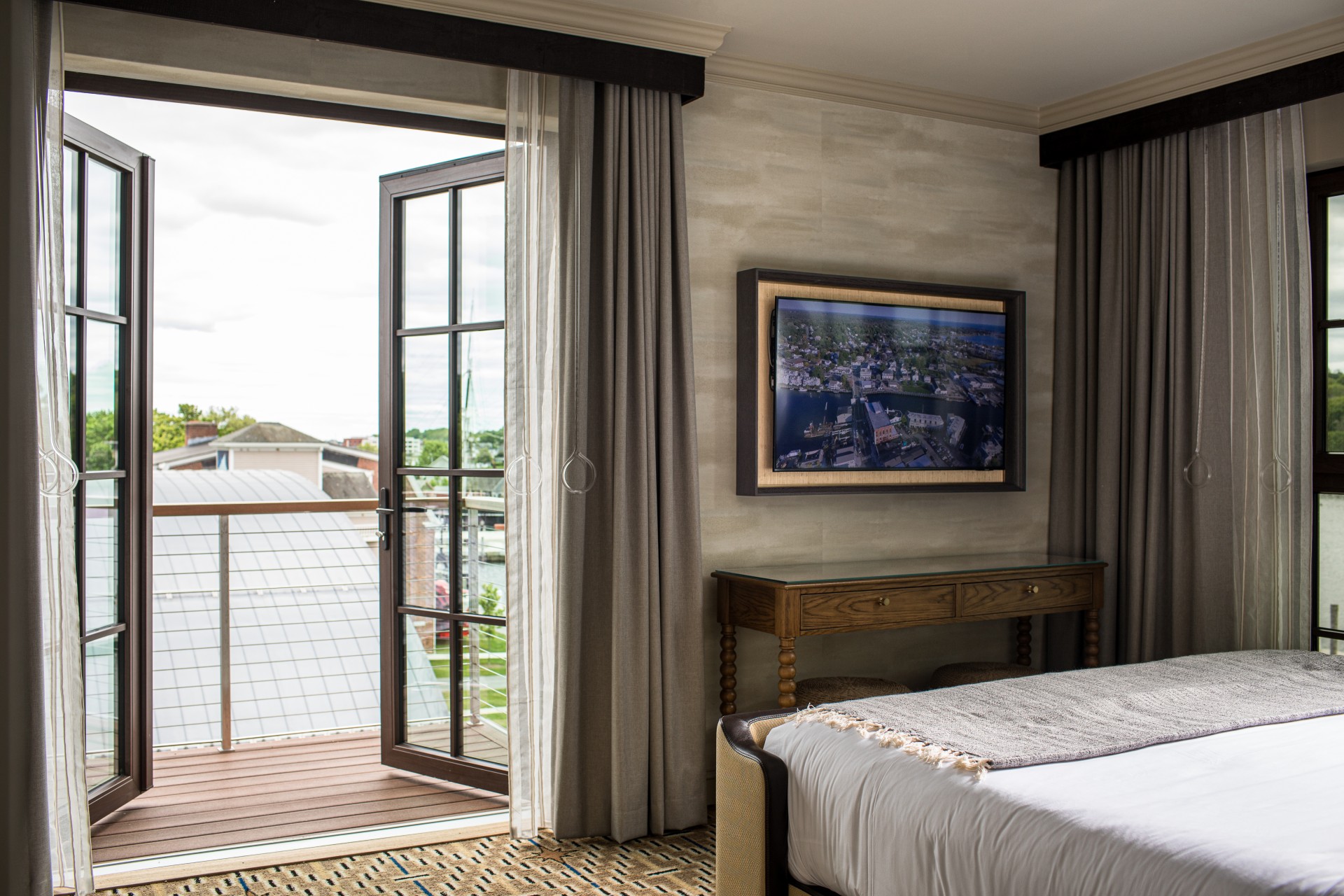 a bedroom with a bed and a television on the wall