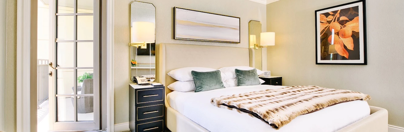 a bed with a large mirror and a lamp