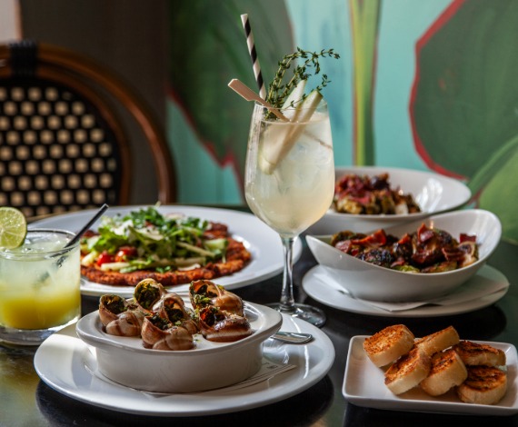 a table with plates of food and drinks