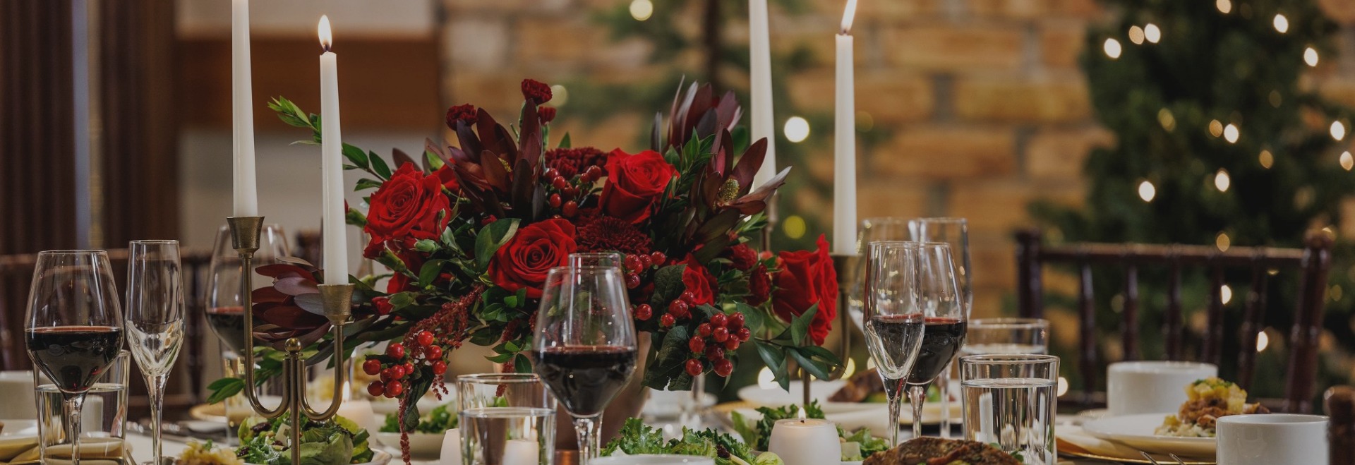 a table with wine glasses and flowers