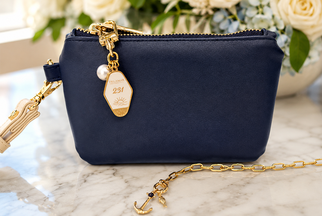 a blue purse with a gold tag on it