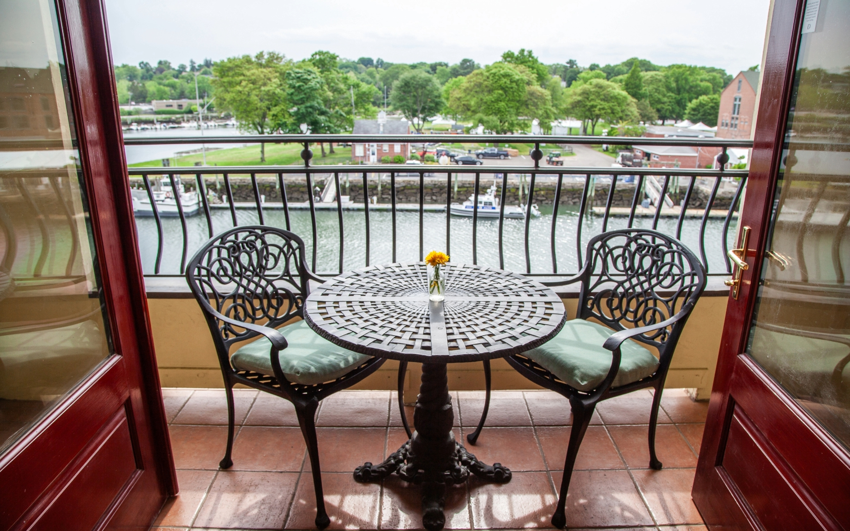 a table and chairs on a balcony overlooking a river