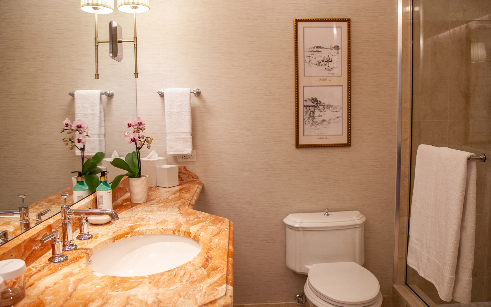 a bathroom with a marble countertop sink and toilet