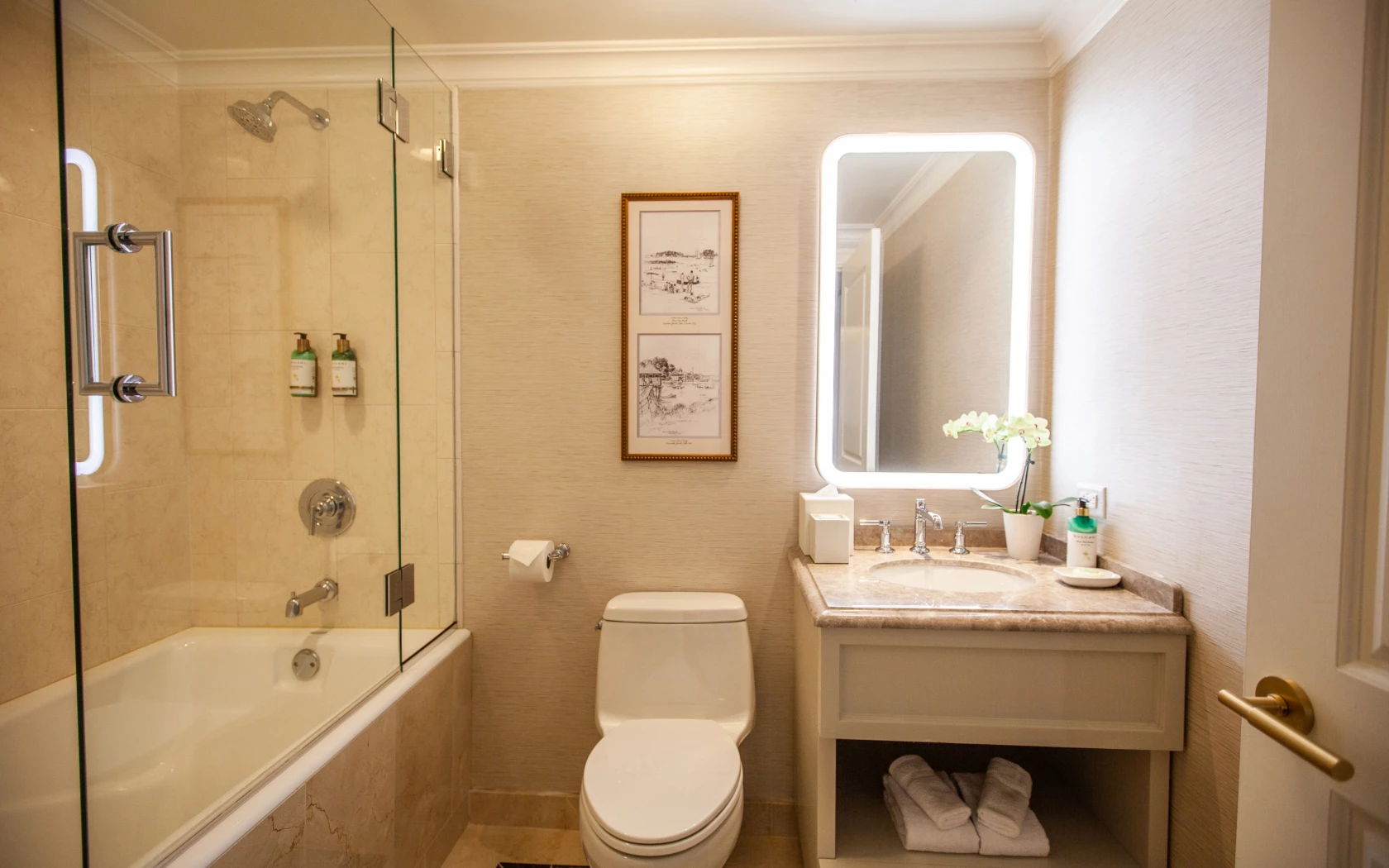 A clean and well-appointed bathroom with a shower, bathtub, toilet, sink, and mirror.