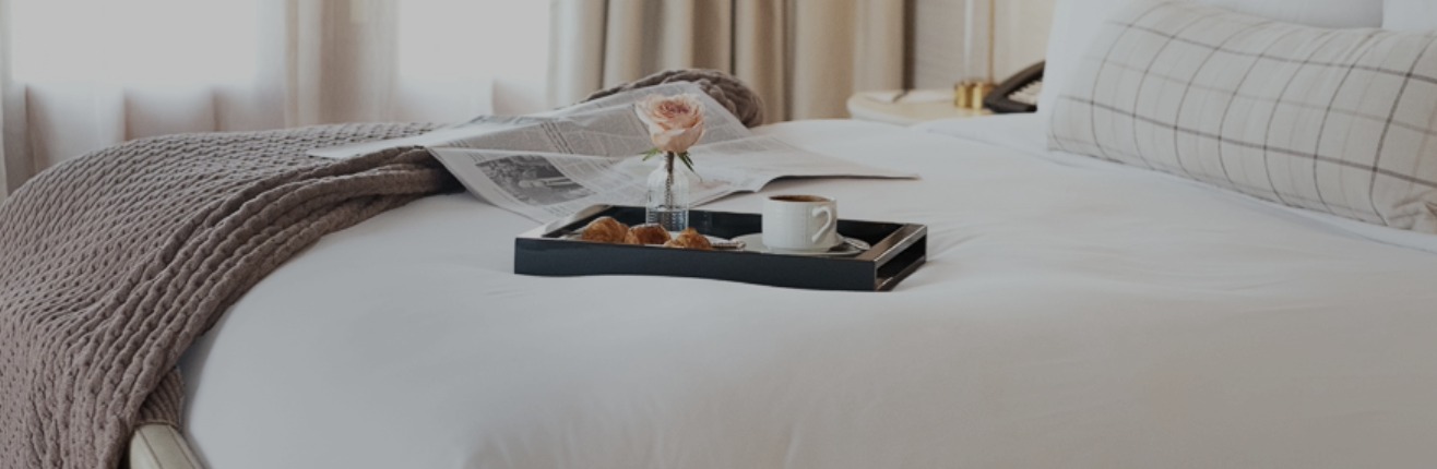 a tray of breakfast on a bed