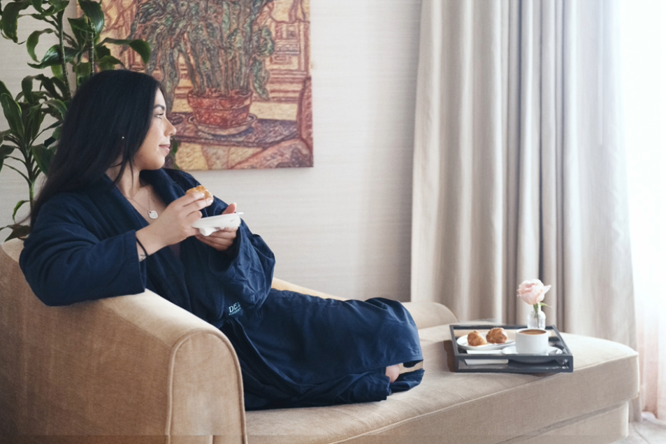 a woman sitting on a couch eating food