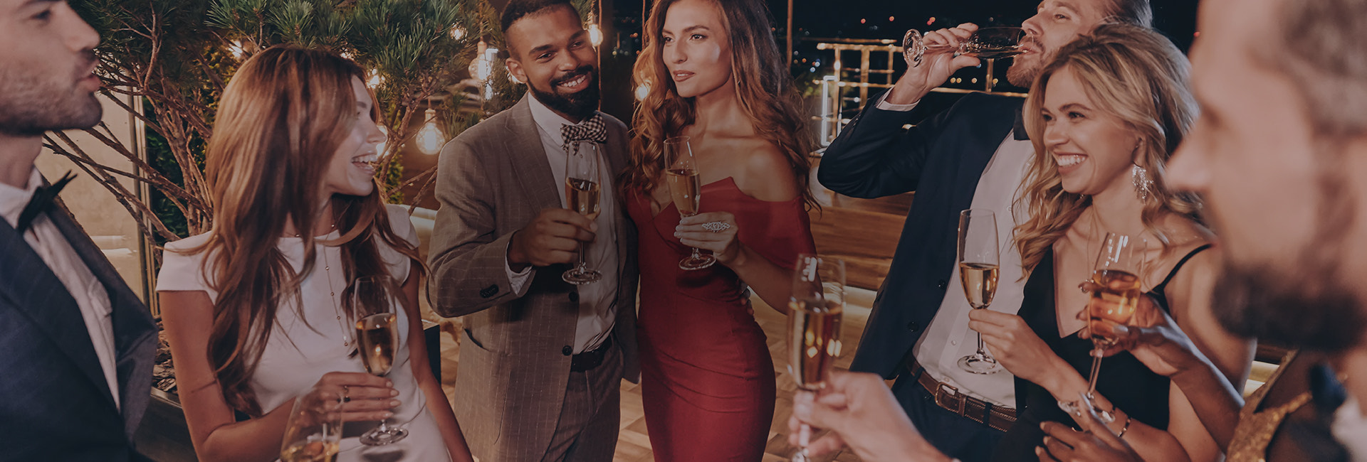 a group of people holding wine glasses