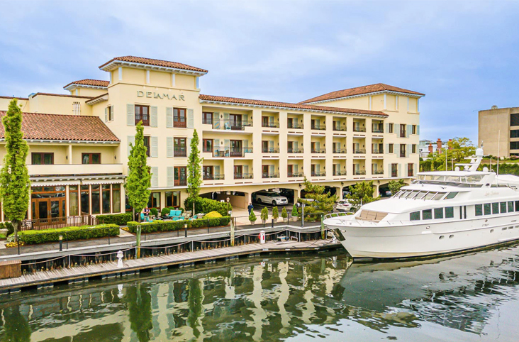 a yellow building with a boat in the water