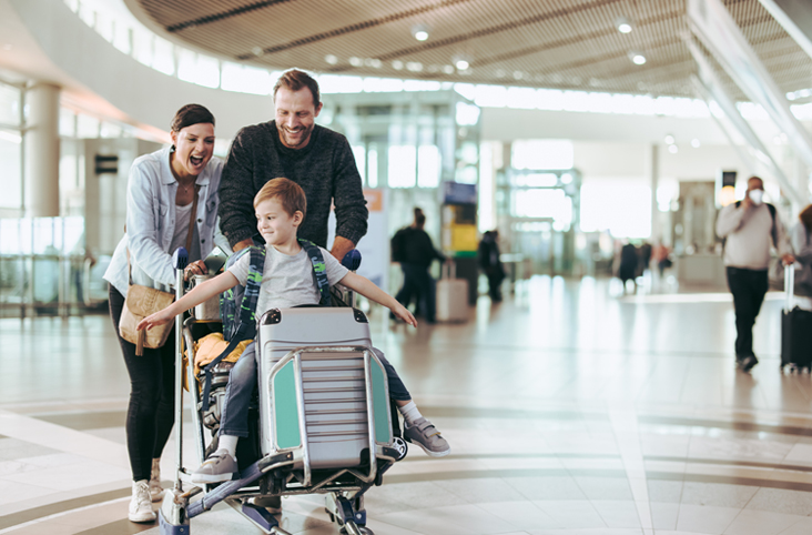 a man and woman pushing a child in a cart