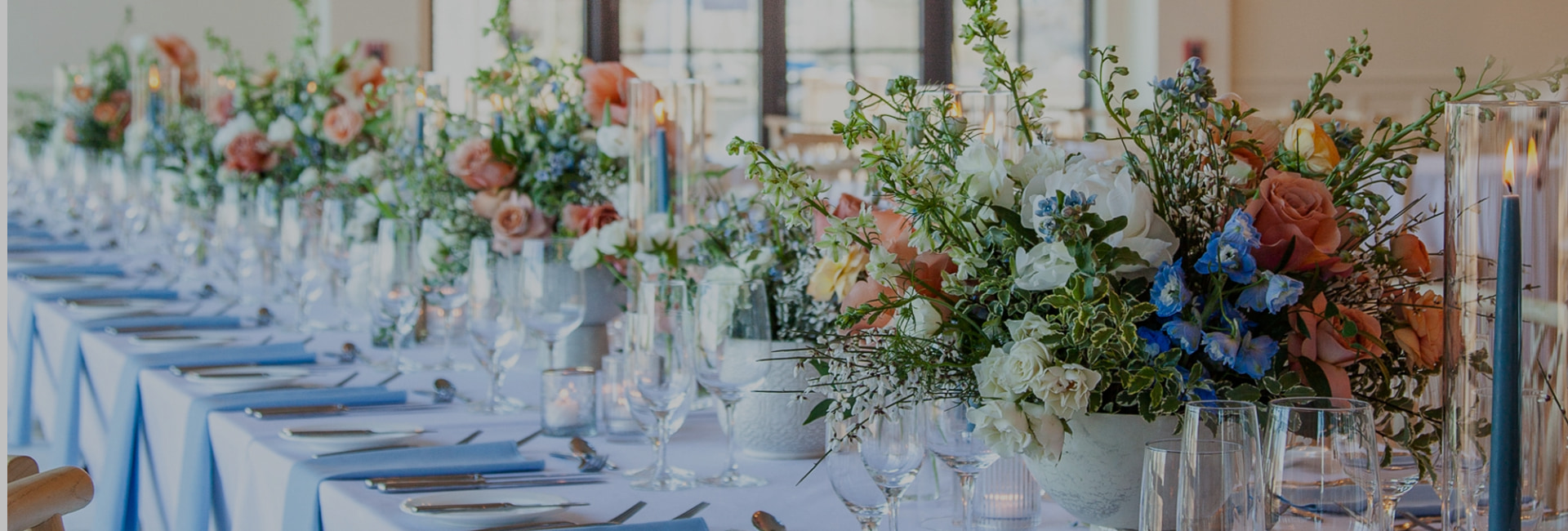 a table with flowers and wine glasses
