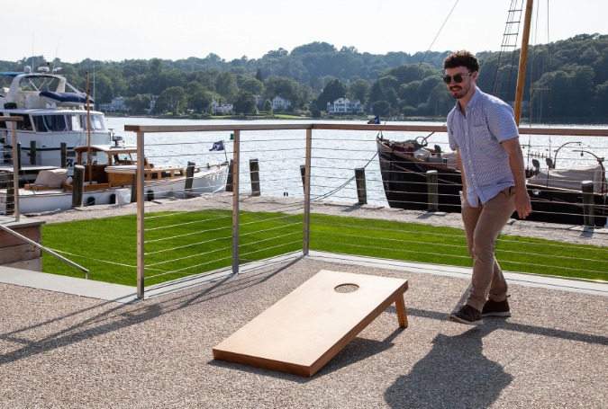 a man standing next to a board