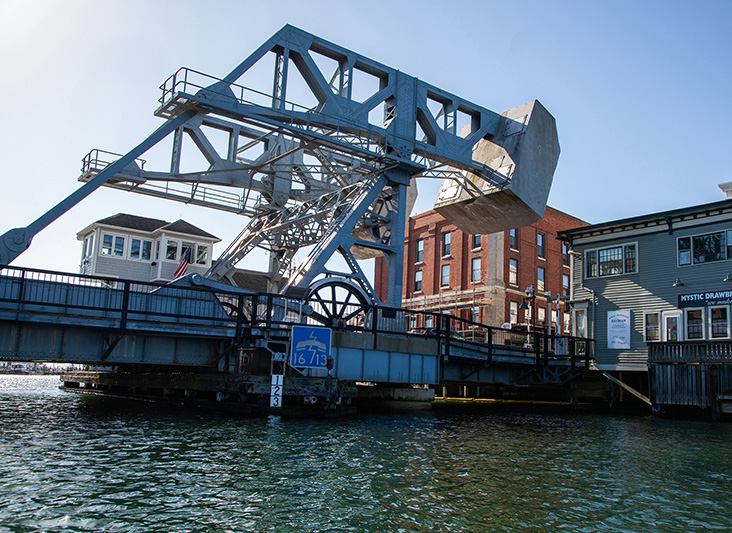 a bridge over water with buildings in the background