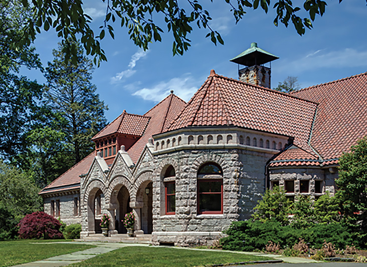 a stone building with a red roof
