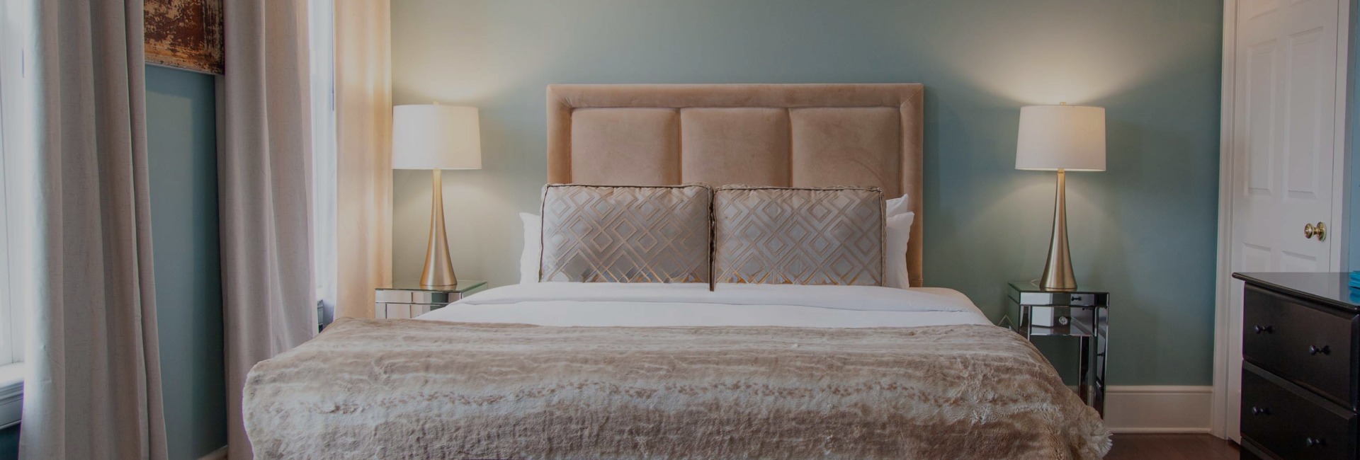 a bed with a lamp on the side