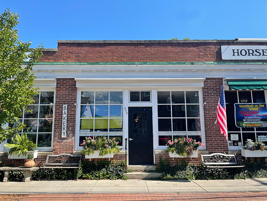 a brick building with a black door and windows