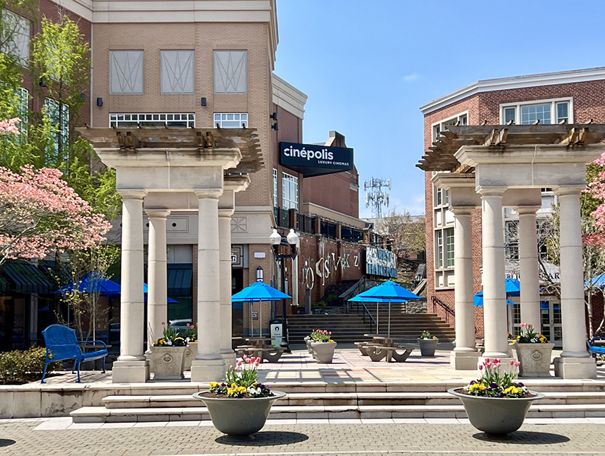 a building with blue umbrellas and columns