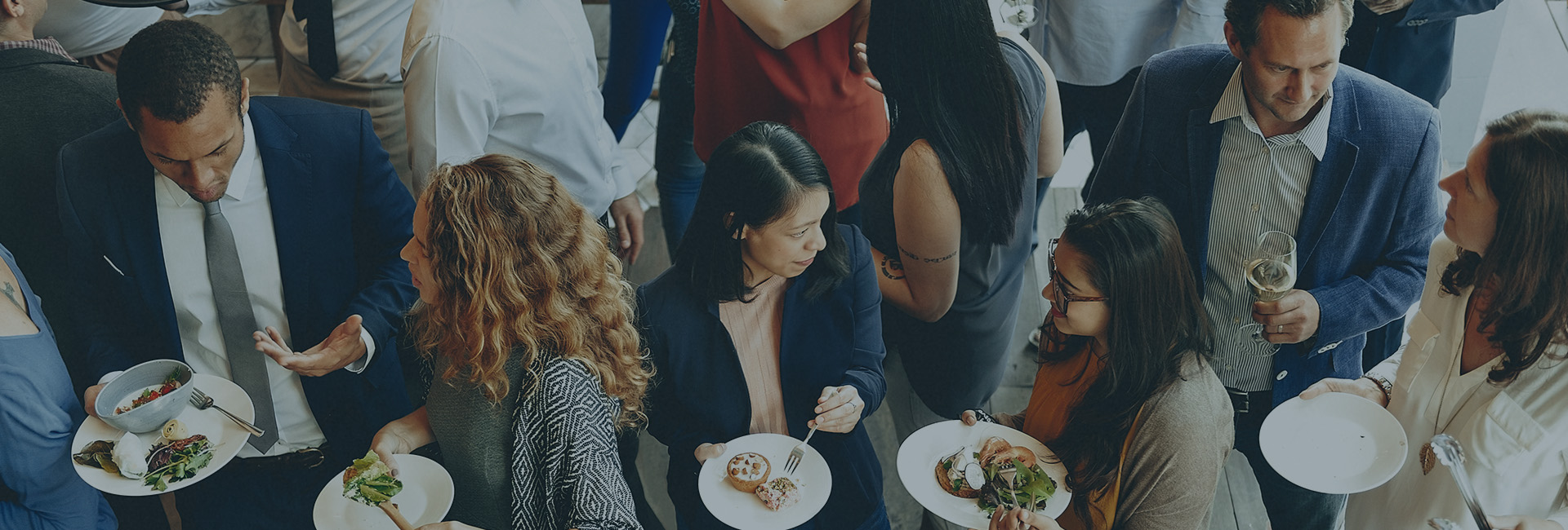 Men and woman conversing and eating 