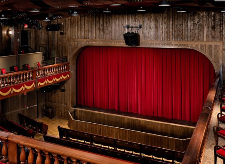a theater with a red curtain