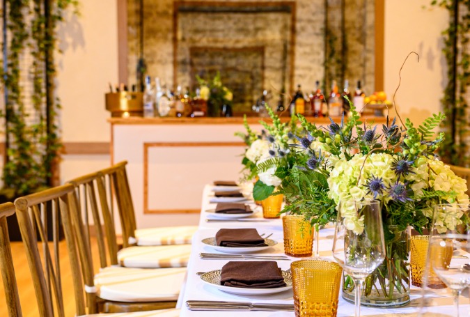 a table set with plates and flowers