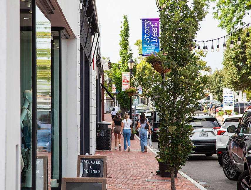 people walking down a sidewalk