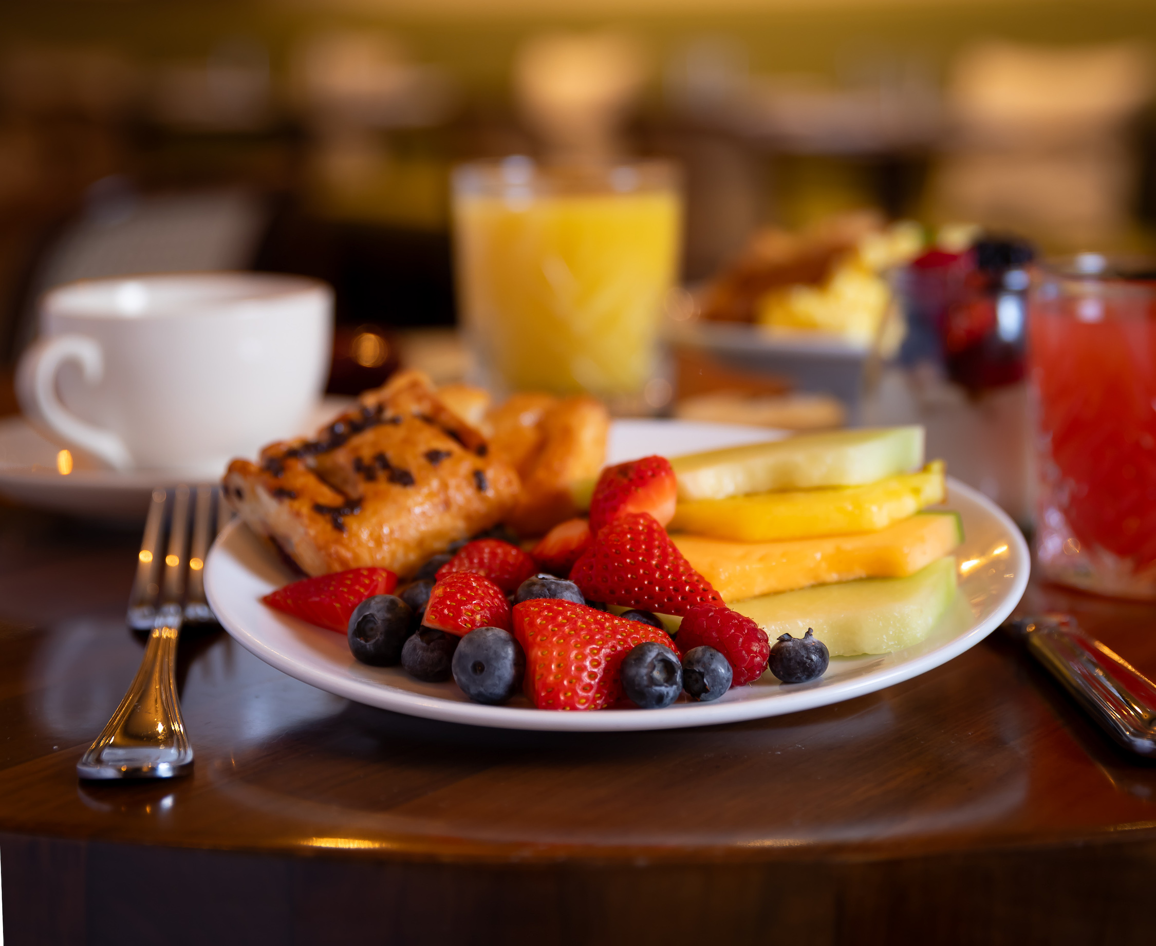 a plate with fruit and a pastry