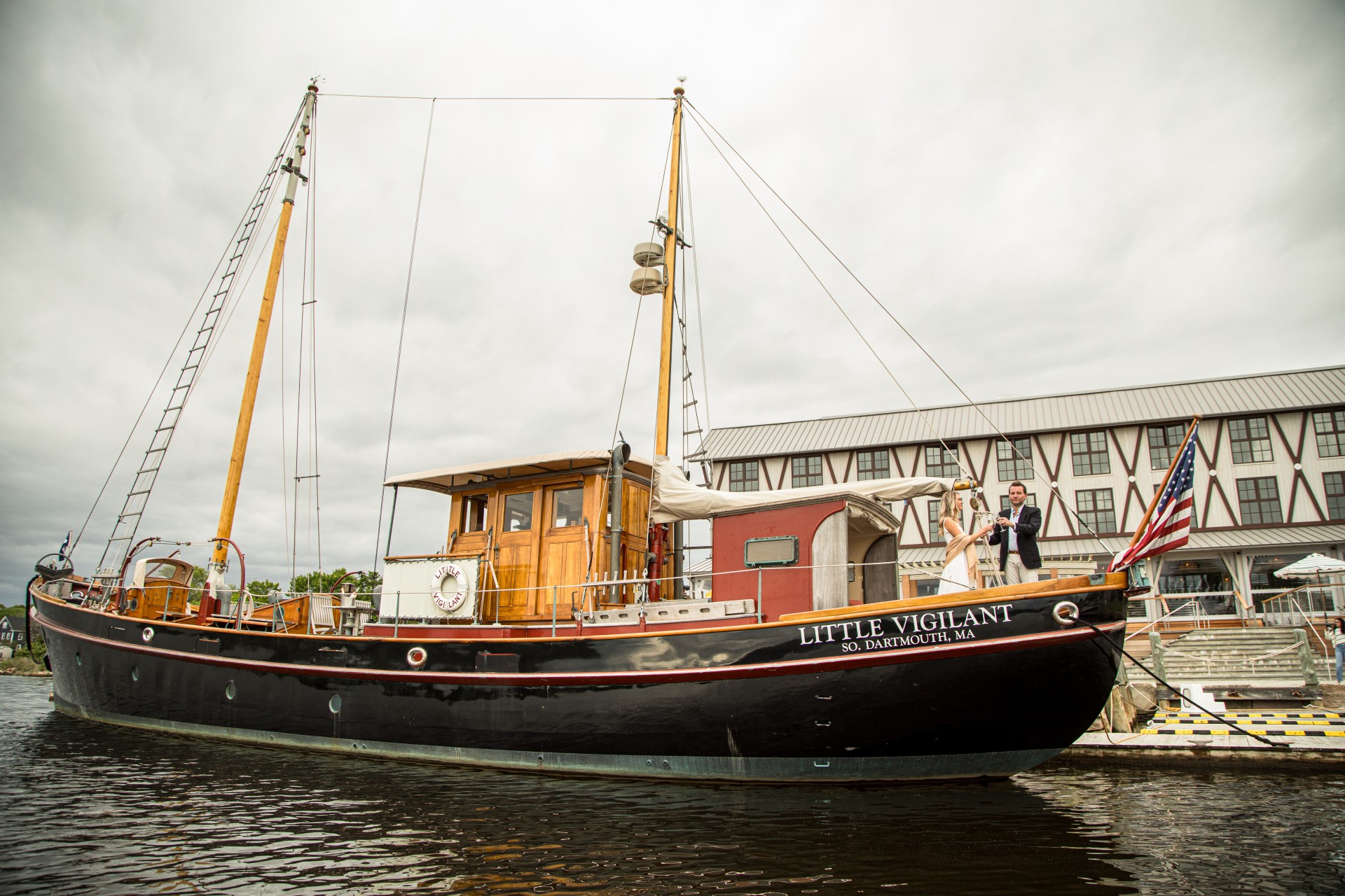 a man and woman standing on a boat